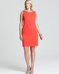 A gleaming gold accent elevates the classic Calvin Klein Plus dress, flaunting diagonal seaming for effortless figure flattery. A gleaming gold accent elevates the classic Calvin Klein Plus dress, flaunting diagonal seaming for effortless figure flattery.