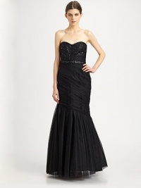 This floor-length tulle silhouette features a sexy corset bodice and delicate beaded details.Strapless sweetheart necklineBeaded, boned corset bodiceBeaded waistbandDraped trumpet skirtConcealed side zipTaffeta liningAbout 63 from shoulder to hemPolyesterDry cleanImportedModel shown is 5'10 (177cm)wearing US size 4. This floor-length tulle silhouette features a sexy corset bodice and delicate beaded details.Strapless sweetheart necklineBeaded, boned corset bodiceBeaded waistbandDraped trumpet skirtConcealed side zipTaffeta liningAbout 63 from shoulder to hemPolyesterDry cleanImportedModel shown is 5'10 (177cm)wearing US size 4.