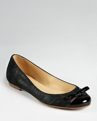 Shine in kate spade new york's Holland ballet flats, accented with patent leather cap toes finished off with brilliant bows. Shine in kate spade new york's Holland ballet flats, accented with patent leather cap toes finished off with brilliant bows.