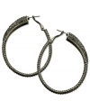 Gray matters on these sparkling clutchless hoops from GUESS. Pave crystals adorn a classic earring silhouette. Crafted in hematite tone mixed metal. Approximate drop: 2-1/4 inches.