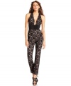 Stunning. Striking. Sexy. Make those statements and more in BCBGMAXAZRIA's sultry lace jumpsuit, featuring a deep, dramatic neckline and banded waist.