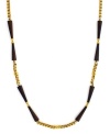An earthy-cool blend. Vince Camuto combines wooden beads with an intricate box chain in gold tone mixed metal on this long, luxurious style. Approximate length: 36 inches.