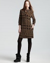Classic tweed goes contemporary as a graphic version of the signature check lends impact presence to a Burberry Brit silk dress.