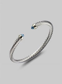 From the Color Classics Collection. A graceful sterling silver cable, capped with faceted blue topaz domes and accents of 14k gold. Blue topaz Sterling silver and 14k yellow gold Cable, 5mm Diameter, about 2¼ Imported From the Color Classics Collection. A graceful sterling silver cable, capped with faceted blue topaz domes and accents of 14k gold. Blue topaz Sterling silver and 14k yellow gold Cable, 5mm Diameter, about 2¼ Imported