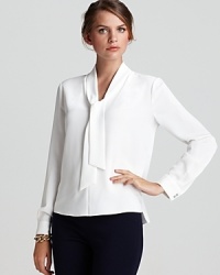 Brimming with modern romance, this T Tahari blouse flaunts a generous tie collar and sheer silhouette for a stunning feminine style. Brimming with modern romance, this T Tahari blouse flaunts a generous tie collar and sheer silhouette for a stunning feminine style.