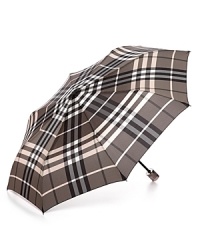 Easily stowed, this classic check umbrella from Burberry boasts endless style in a compact size. Easily stowed, this classic check umbrella from Burberry boasts endless style in a compact size.