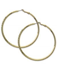 Shine like gold. These classic hoop earrings from GUESS showcase subtle texture for added style. Crafted in gold tone mixed metal. Approximate diameter: 2-1/2 inches. Shine like gold. These classic hoop earrings from GUESS showcase subtle texture for added style. Crafted in gold tone mixed metal. Approximate diameter: 2-1/2 inches.