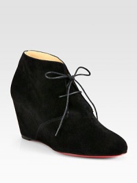 Trend-forward suede ankle boot has a lace-up front, self-covered wedge and signature red leather sole. Self-covered wedge, 3 (75mm)Suede upperLeather liningSignature red leather solePadded insoleMade in ItalyOUR FIT MODEL RECOMMENDS ordering one half size up as this style runs small. Trend-forward suede ankle boot has a lace-up front, self-covered wedge and signature red leather sole. Self-covered wedge, 3 (75mm)Suede upperLeather liningSignature red leather solePadded insoleMade in ItalyOUR FIT MODEL RECOMMENDS ordering one half size up as this style runs small.