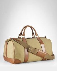Invoking the classic feel of gentlemen's vintage sporting holdalls, an essential gym bag is crafted from sturdy canvas with rich leather trim and an embossed signature luggage tag for timeless style. Invoking the classic feel of gentlemen's vintage sporting holdalls, an essential gym bag is crafted from sturdy canvas with rich leather trim and an embossed signature luggage tag for timeless style.