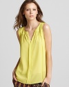 Exude sunshine in this luminous Twelfth Street by Cynthia Vincent sleeveless blouse, featuring epaulets at the shoulders with light gathering and a single pleat through the front. The perfect dress-up piece for casual separates, the semi-sheer style is a worthy purchase.