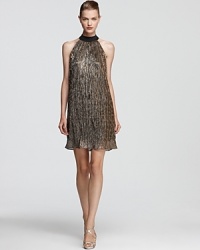 Laundry by Shelli Segal channels disco dressing with this dazzling metallic dress, detailing with micropleating and a dramatic, high neckline. Laundry by Shelli Segal channels disco dressing with this dazzling metallic dress, detailing with micropleating and a dramatic, high neckline.
