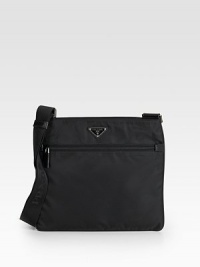 Tessuto nylon messenger with saffiano leather trim and adjustable shoulder strap.Top zip closure One outside zip pocket One inside zip pocket Triangle metal and enamel Prada logo Logo lining 12W X 10H X 2¾D Made in Italy 