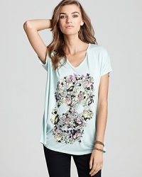 We're intrigued by this mystical floral skull print that instantly attracts smiles and double takes from onlookers--give your wardrobe a stylish boost with this one-of-a-kind looking Lauren Moshi tee. We're intrigued by this mystical floral skull print that instantly attracts smiles and double takes from onlookers--give your wardrobe a stylish boost with this one-of-a-kind looking Lauren Moshi tee.