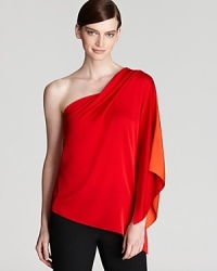 Fluid silks cascades the length of a one-shoulder Elie Tahari blouse for a striking feminine silhouette. Fluid silks cascades the length of a one-shoulder Elie Tahari blouse for a striking feminine silhouette.