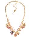 Clusters of charms. Betsey Johnson's antique gold tone mixed metal necklace features a gold-tone rose, bows with ombre pave crystal accents, gold-tone bubble hearts, a hematite-plated bow with pink crystal accent, and pink faceted beads all on a gold-tone necklace chain with pink crystal cup chain accents. Approximate length: 16 inches + 3-inch extender. Approximate drop: 1-1/2 inches.
