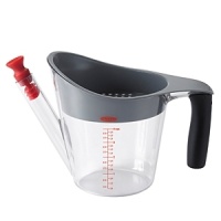 Cut the fat with the OXO GOOD GRIPS Fat Separator, now available in a convenient 2-cup size. Pour gravy into the Separator and watch the fat rise to the top while lean gravy settles to the bottom. The heat resistant strainer catches unwanted bits, and the stopper prevents fat from rising to the top of the spout. Once the gravy has settled, remove the strainer and the stopper and pour out perfect gravy. A shield prevents the gravy from spilling over the top of the Separator instead of through the spout. This heat resistant Fat Separator has measurement markings for increased convenience and a non-slip handle for a comfortable, firm grip. Cut the fat with the OXO GOOD GRIPS Fat Separator, now available in a convenient 2-cup size. Pour gravy into the Separator and watch the fat rise to the top while lean gravy settles to the bottom. The heat resistant strainer catches unwanted bits, and the stopper prevents fat from rising to the top of the spout. Once the gravy has settled, remove the strainer and the stopper and pour out perfect gravy. A shield prevents the gravy from spilling over the top of the Separator instead of through the spout. This heat resistant Fat Separator has measurement markings for increased convenience and a non-slip handle for a comfortable, firm grip.