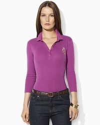 Sleek gold-toned buttons and a metallic embroidered crest lend regal elegance to a soft cotton polo shirt. Sleek gold-toned buttons and a metallic embroidered crest lend regal elegance to a soft cotton polo shirt.