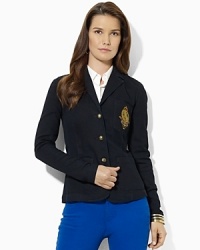 A wardrobe essential, a chic three-button blazer is crafted in stretch denim and finished with a signature crest at the chest. A wardrobe essential, a chic three-button blazer is crafted in stretch denim and finished with a signature crest at the chest.
