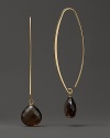 Faceted drops of smoky quartz dangle from slim oval hoops of 14K yellow gold.