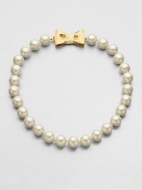 A classic styled piece in pearl-like beads with a sweet goldtone bow closure. Plastic beadsGoldtoneLength, about 18Tongue and box closureImported A classic styled piece in pearl-like beads with a sweet goldtone bow closure. Plastic beadsGoldtoneLength, about 18Tongue and box closureImported
