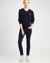 Ultra-soft cotton v-neck with dropped shoulders and a sweet heart design on the chest. V-neck Dropped shoulders Long sleeves Ribbed cuffs and hem Cotton Dry clean Imported