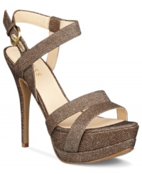 Teeter along in this tall, sexy style. The Geary platform sandals by GUESS feature a sparkly fabric upper with wrap-around ankle strap enclosure and side buckle. Teeter along in this tall, sexy style. The Geary platform sandals by GUESS feature a sparkly fabric upper with wrap-around ankle strap enclosure and side buckle.