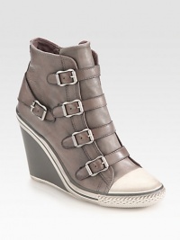 Leather ankle boot surrounded by adjustable buckles has a rubber wedge, side zipper and sneaker-inspired toecap. Rubber wedge, 3 (75mm)Leather upperSide zipperLeather liningRubber solePadded insoleImportedOUR FIT MODEL RECOMMENDS ordering one half size up as this style runs small. Leather ankle boot surrounded by adjustable buckles has a rubber wedge, side zipper and sneaker-inspired toecap. Rubber wedge, 3 (75mm)Leather upperSide zipperLeather liningRubber solePadded insoleImportedOUR FIT MODEL RECOMMENDS ordering one half size up as this style runs small.
