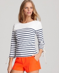 A flattering boat neckline freshens up this Juicy Couture nautical tee, while lace-up detail on the sleeves updates the classic trend.