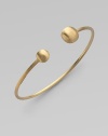 From the Africa Collection. Two 18k yellow gold orbs bookend this open bangle design.18k yellow gold Diameter, about 7 Made in Italy 