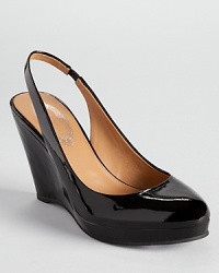 Elie Tahari's glossy Alexia wedges showcase a classic slingback silhouette and timeless style. Elie Tahari's glossy Alexia wedges showcase a classic slingback silhouette and timeless style.