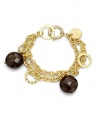 THE LOOKA graceful double chain with textured linksFaceted smoky quartz beads alternate with flat, polished open discsOversized spring ring claspTHE FITLength, about 7½THE MATERIALSmoky quartz18k gold platingORIGINMade in Italy