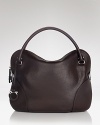 A sleek, chic leather hobo with contemporary panel details and a clever lockable top zip. By Salvatore Ferragamo.