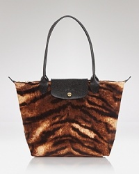 The epitome of laid back luxe: Longchamp's signature shoulder bag is updated in a fierce fashion print, styled to for workday to weekend chic. The epitome of laid back luxe: Longchamp's signature shoulder bag is updated in a fierce fashion print, styled to for workday to weekend chic.