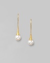 Delicate freshwater pearls dangle from hand-hammered 24k gold settings. 8mm white, round freshwater pearls 24k yellow gold Length, about 1¼ 22k gold ear wire Imported