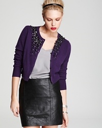 An embellished neckline lends a touch of punk to a preppy Magaschoni cardigan. Team with a leather skirt and rock n' roll to the top of the fashion set. An embellished neckline lends a touch of punk to a preppy Magaschoni cardigan. Team with a leather skirt and rock n' roll to the top of the fashion set.