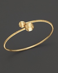 Bold, textured beads anchor this 18K yellow gold bangle. From the Marco Bicego Africa Collection. Bold, textured beads anchor this 18K yellow gold bangle. From the Marco Bicego Africa Collection.