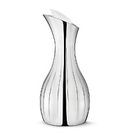 The Georg Jensen Legacy collection is a perfect illustration of how a more decorative style incorporated into modern design can result in a gorgeous piece - the smooth, curved surfaces are mirroring their surroundings in a world of glittering sumptuousness. The Georg Jensen Legacy pitcher is ideal for pouring water or juice, for example. The decorative grooves provide a firm grip while the pitcher insulating design ensures that ice water stays cold for a while. The Georg Jensen Legacy pitcher is made of stainless steel and comes with an elegant white stopper. The Georg Jensen Legacy collection is a perfect illustration of how a more decorative style incorporated into modern design can result in a gorgeous piece - the smooth, curved surfaces are mirroring their surroundings in a world of glittering sumptuousness. The Georg Jensen Legacy pitcher is ideal for pouring water or juice, for example. The decorative grooves provide a firm grip while the pitcher insulating design ensures that ice water stays cold for a while. The Georg Jensen Legacy pitcher is made of stainless steel and comes with an elegant white stopper.