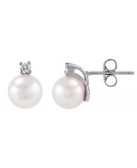 Crafted on the island of Mallorca, Spain, these lustrous man-made pearls (8 mm) shimmer with the addition of round-cut cubic zirconia accents. Stud earrings by Majorica set in sterling silver. Crafted on the island of Mallorca, Spain, these lustrous man-made pearls (8 mm) shimmer with the addition of round-cut cubic zirconia accents. Stud earrings by Majorica set in sterling silver.