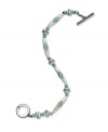 A serene touch of blue blends wonderfully with industrial silver on this Lauren by Ralph Lauren toggle bracelet. Crafted with antiqued silver tone mixed metal with reconstituted turquoise beads accents. Approximate length: 7-1/2 inches.
