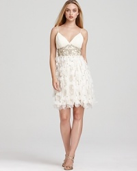 Sweet but not so innocent, this softly petaled dress is a statement in pure femininity. Pleated v-neckline stops at an inset empire waist bedazzled with tonal beads and sequins. Petal skirt ends with a bouncy bubble hem. With adjustable, lingerie straps and built-in bra padded lining. Invisible side zip with hook/eye closure. Sweet but not so innocent, this softly petaled dress is a statement in pure femininity. Pleated v-neckline stops at an inset empire waist bedazzled with tonal beads and sequins. Petal skirt ends with a bouncy bubble hem. With adjustable, lingerie straps and built-in bra padded lining. Invisible side zip with hook/eye closure.