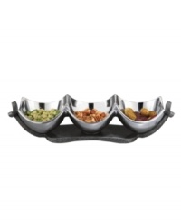 Set or simply decorate the table with the ultra-modern Anvil condiment bowl from Nambe's collection of serveware and serving dishes. A sculptural, iron-finished base cradles contoured silvertone alloy in this innovative Neil Cohen design. Set or simply decorate the table with the ultra-modern Anvil condiment bowl from Nambe's collection of serveware and serving dishes. A sculptural, iron-finished base cradles contoured silvertone alloy in this innovative Neil Cohen design.