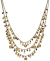 Lauren Ralph Lauren's exotic three-row necklace combines semi-precious tiger's eye beads with glass, resin and wood accents. Set in 14k gold-plated mixed metal. Approximate length: 22 inches + 2-inch extender.