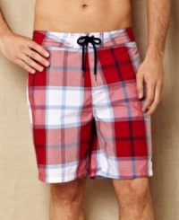 This classic plaid patterned swim trunk from Nautica is updated with a modern length to have you riding a style wave this summer. This classic plaid patterned swim trunk from Nautica is updated with a modern length to have you riding a style wave this summer.