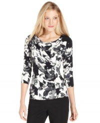 Calvin Klein's printed top features a fitted silhouette and flattering ruching. Calvin Klein's printed top features a fitted silhouette and flattering ruching.
