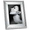 Showcase your most precious pictures with this highly polished silverplate frame embellished with raised dots. Its timeless design will add value to photos and style to your home.
