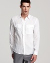 The military-inspired design contrasts with airy linen material for unique designer flair, separating this slim-fitting sport shirt from your average button-down.