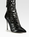 A leather point toe silhouette is amplified with geometric cutouts and an ostrich-print heel for textural appeal. Ostrich-print leather heel, 4¼ (110mm)Leather upperPoint toeBack zipLeather lining and solePadded insoleMade in Italy