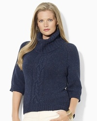 A chunky knit sweater is crafted with an oversized turtleneck and a modern high-low hem. A chunky knit sweater is crafted with an oversized turtleneck and a modern high-low hem.