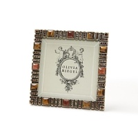 Capri frame with metal back by Olivia Riegel. A striking, modern and warm-hued frame hand-set with Tiger's Eye, Aventurine and Swarovski crystals. Decorative metal back. Capri frame with metal back by Olivia Riegel. A striking, modern and warm-hued frame hand-set with Tiger's Eye, Aventurine and Swarovski crystals. Decorative metal back.