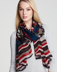With a tribal print in seasonal hues and a bold striped border, this Theodora & Callum oblong scarf is a work of art. With a tribal print in seasonal hues and a bold striped border, this Theodora & Callum oblong scarf is a work of art.